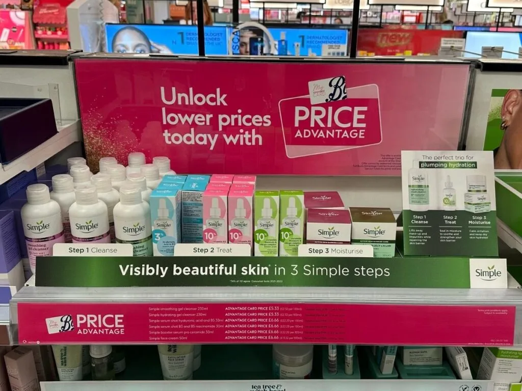 An aisle in Boots showing the advantage card promotion to save money whilst shopping in stone or online