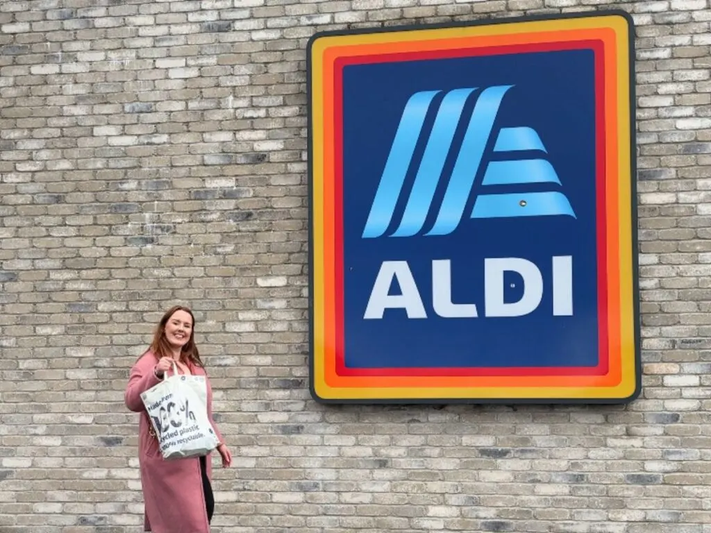 Chloe holding a shopping bag to save money at Aldi