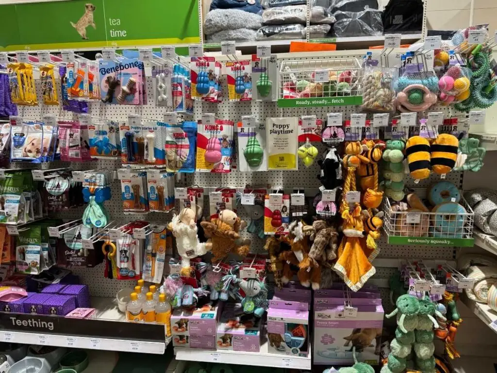 An aisle displaying dog and puppy toys with great deals to save money at Pets at Home