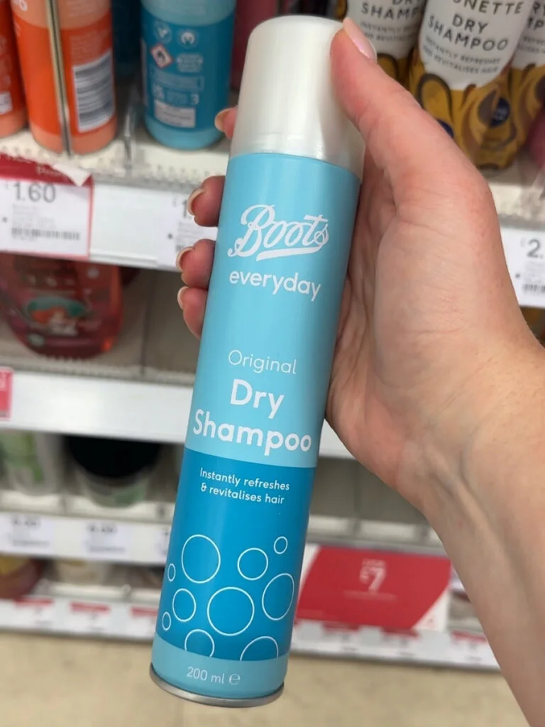 Chloe holding Boots own brand dry shampoo to save money at Boots