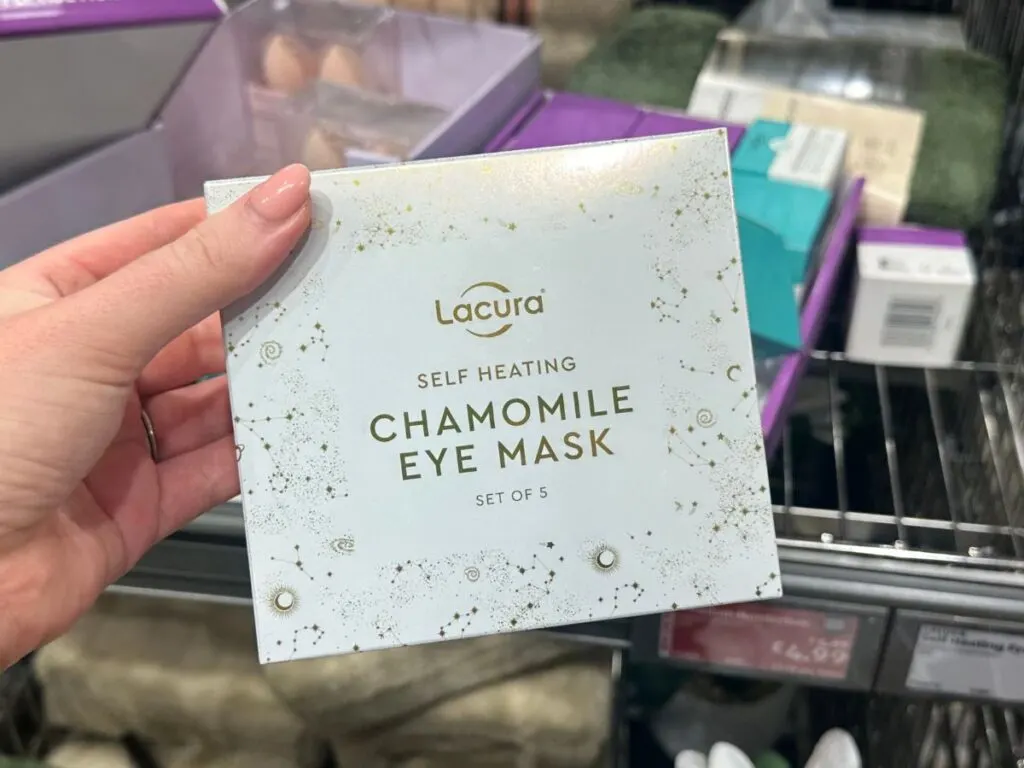 chloe's hand holding a pack of Lacura chamomile eye masks. Dupes are one of Chloe's favourite ways to save money at Aldi