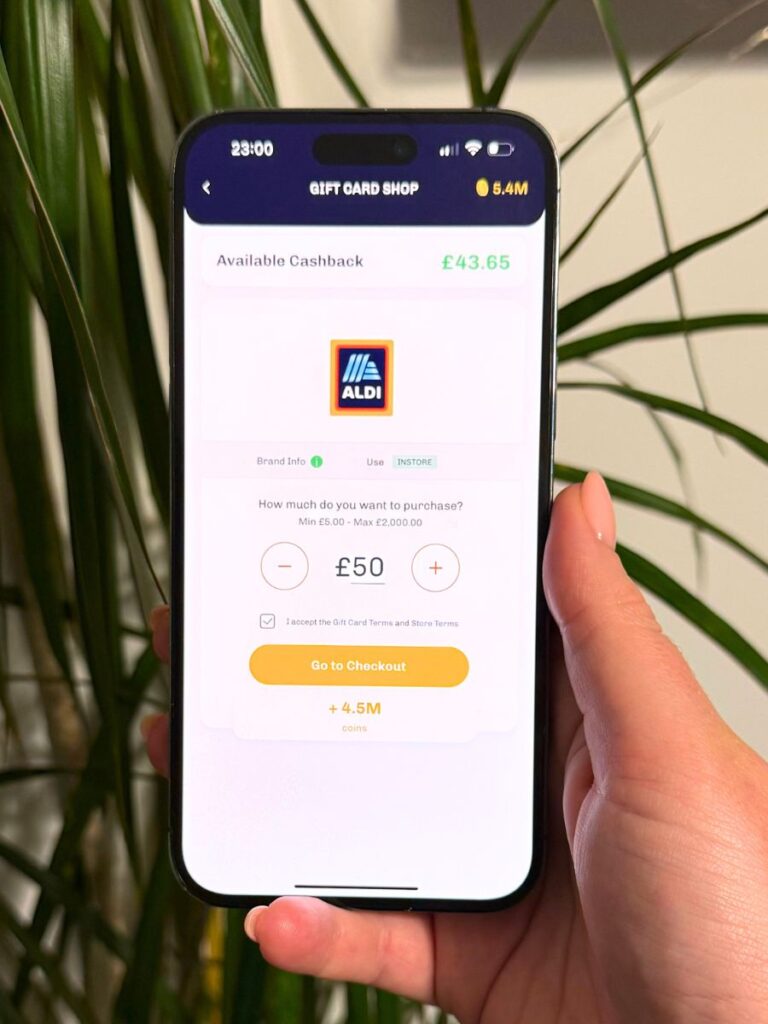 chloe's deal club's hand holding a phone with the everup app showing how to save money at Aldi