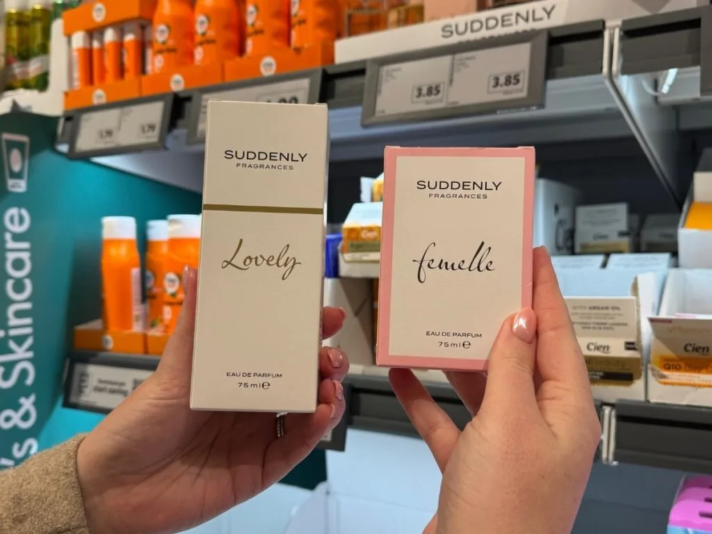 Chloe holding Lidl perfume dupes showing you how to save money when shopping at Lidl