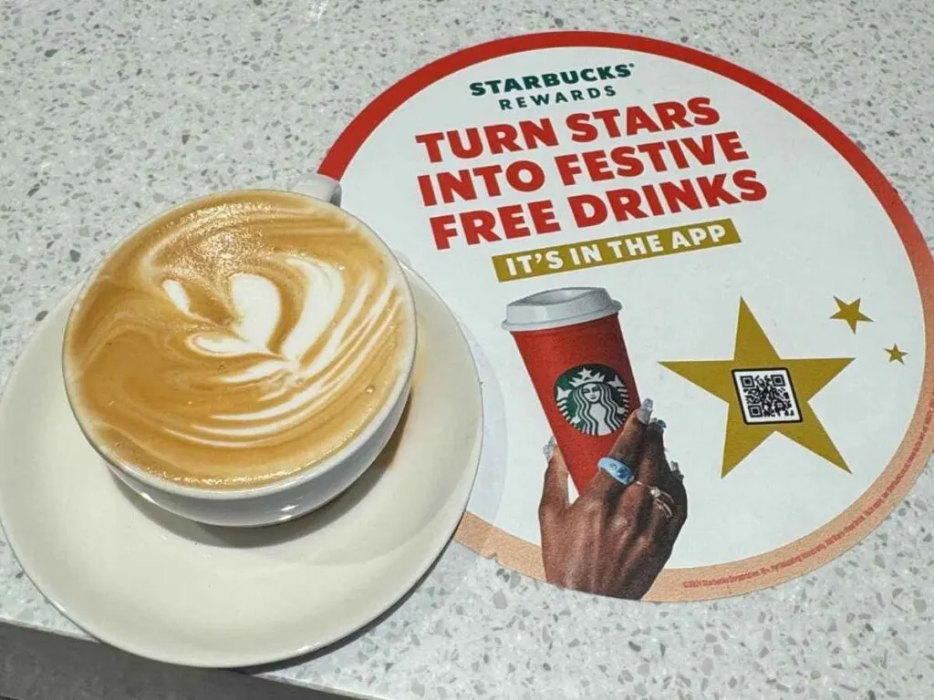 A coffee and sign at Starbucks showing how to get free coffee at Starbucks