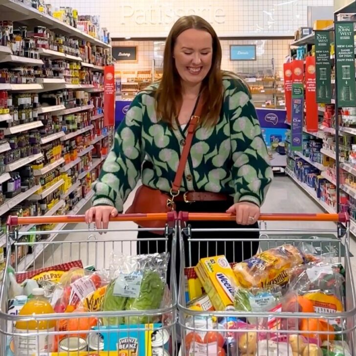 Chloe Carmichael from Chloe's Deal Club standing with two trolleys to show you how to get free food