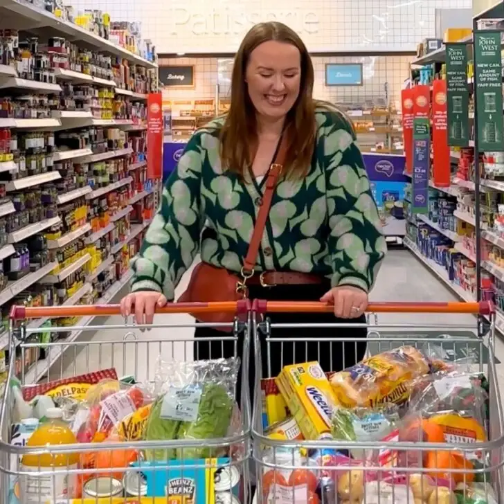 Chloe Carmichael from Chloe's Deal Club standing with two trolleys to show you how to get free food