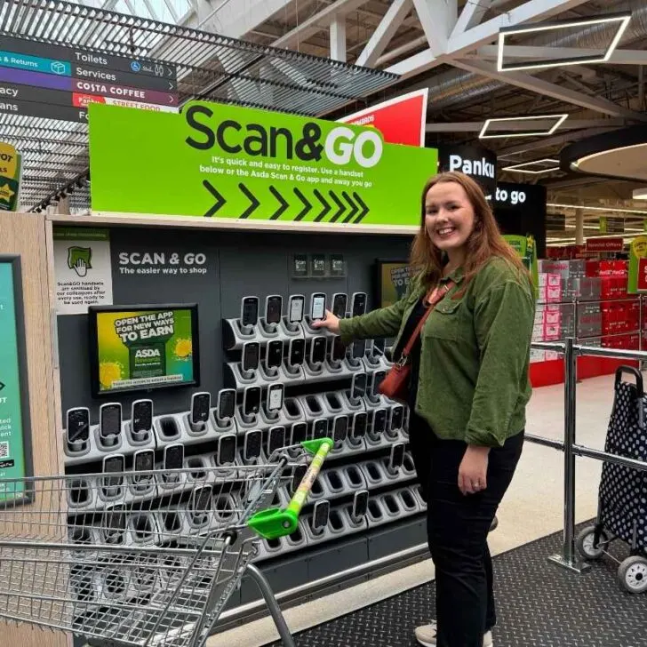 Chloe from Chloe's deal club standing next to the Asda Scan & Go in-store to save money at Asda