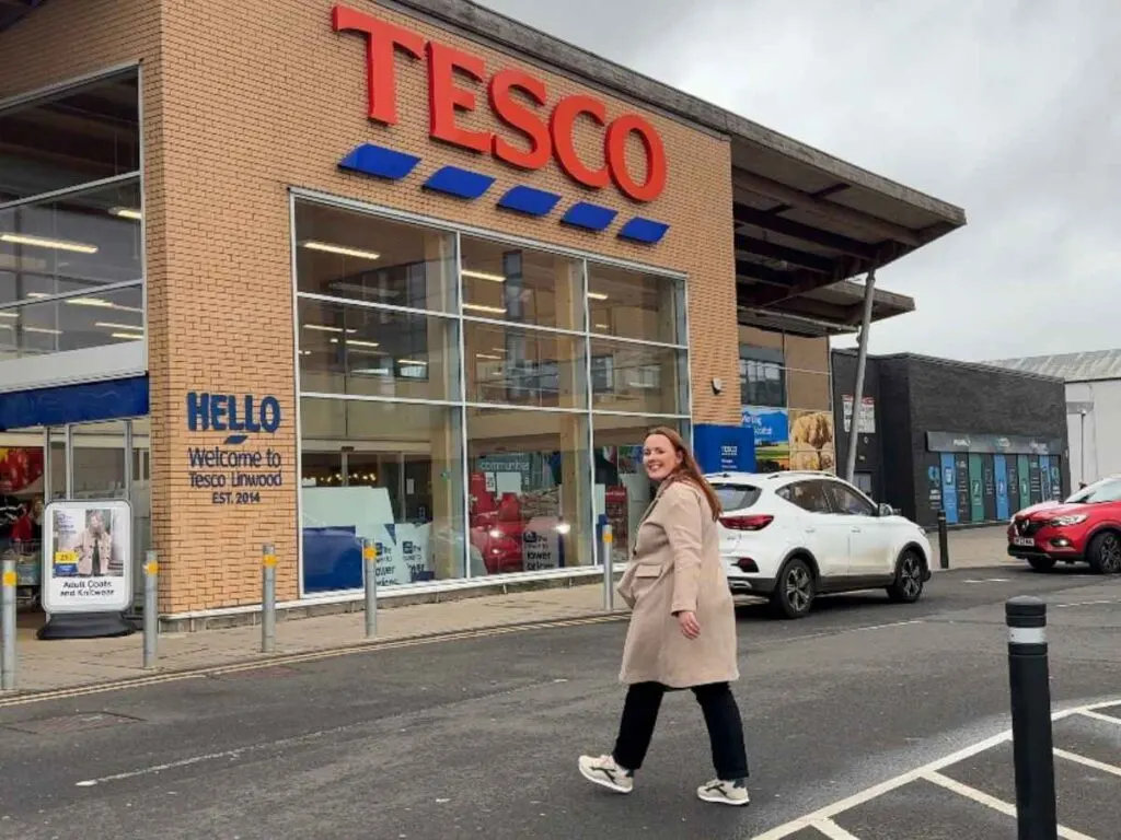 Chloe walking into Tesco to show how to save money on your weekly shop