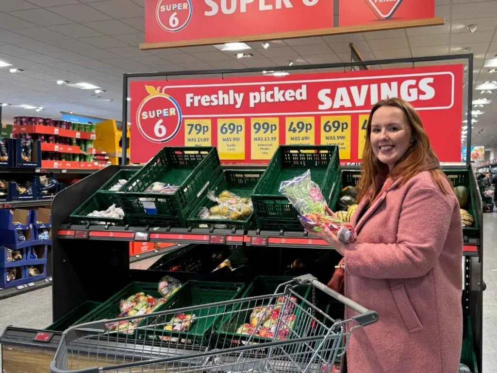 Chloe saving money at Aldi at the Super 6 section