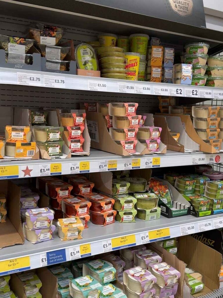 A Tesco supermarket aisle showing products with Clubcard stickers to save money at Tesco 