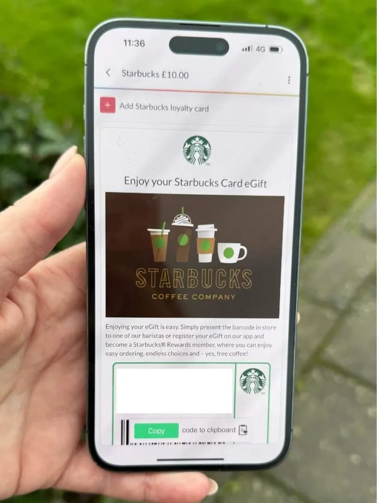 A hand holding a mobile phone displaying gift cards to pay for your coffee and save money