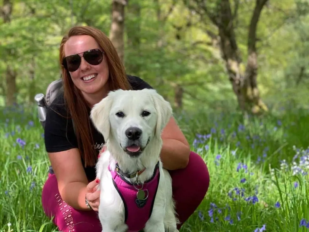 Chloe pictured with dog Poppy outside being paid to walk her dog